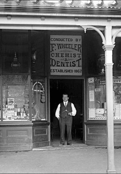 Fred Wheeler standing in front of his Alexandra Chemist and Dentist business. Fred Wheeler standing in front of his Alexandra Chemist and Dentist business.