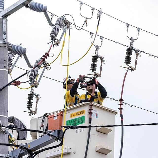 Ausnet technicians fixing powerlines following the storms on Tuesday, February 13.