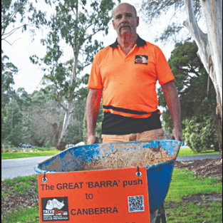Trevor pushing his barrow to Canberra