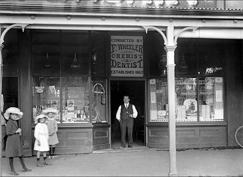 Fred Wheeler standing in front of his Alexandra Chemist and Dentist business.