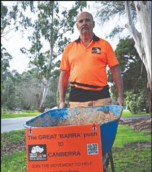 Trevor pushing his barrow to Canberra